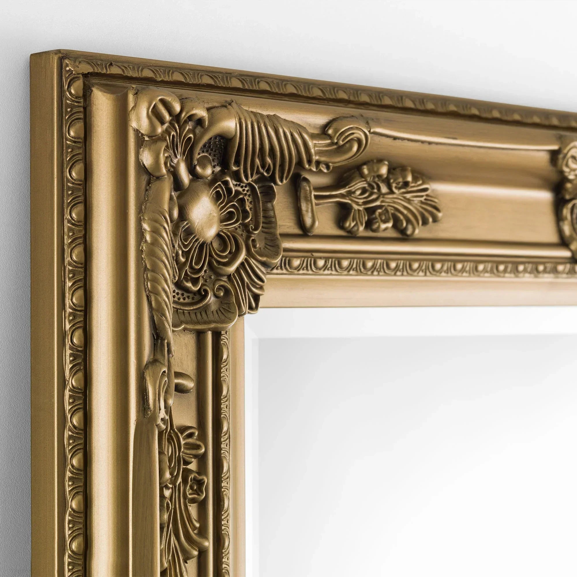 Gold dress mirror corner with ornate baroque style frame detailing