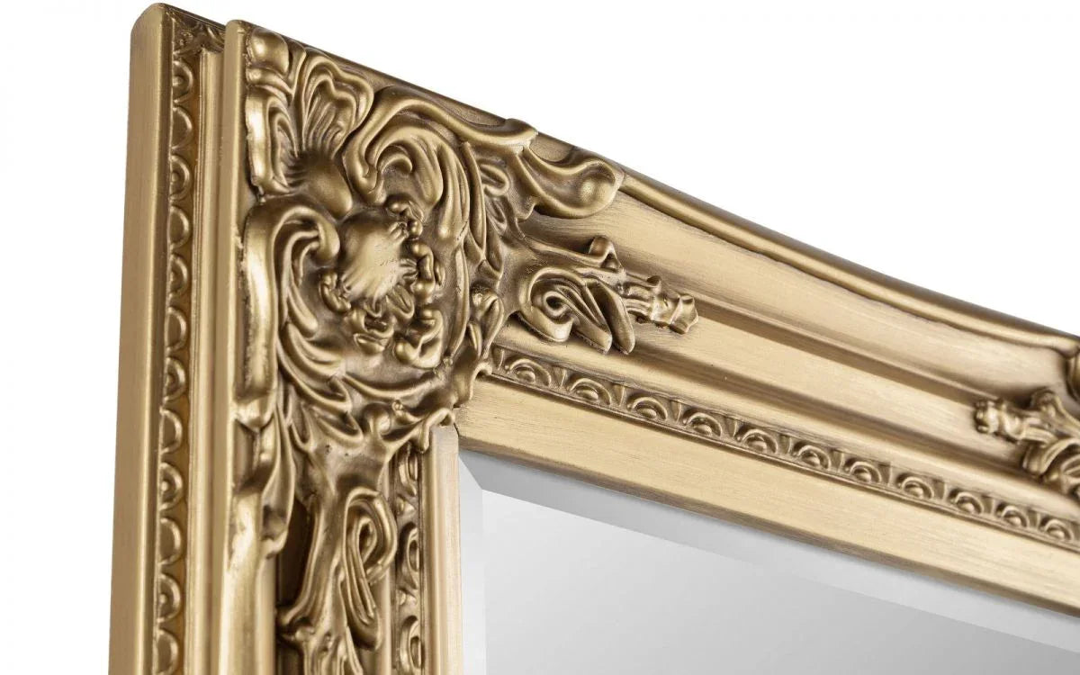 Close-up of ornate gold mirror frame with decorative carved detailing