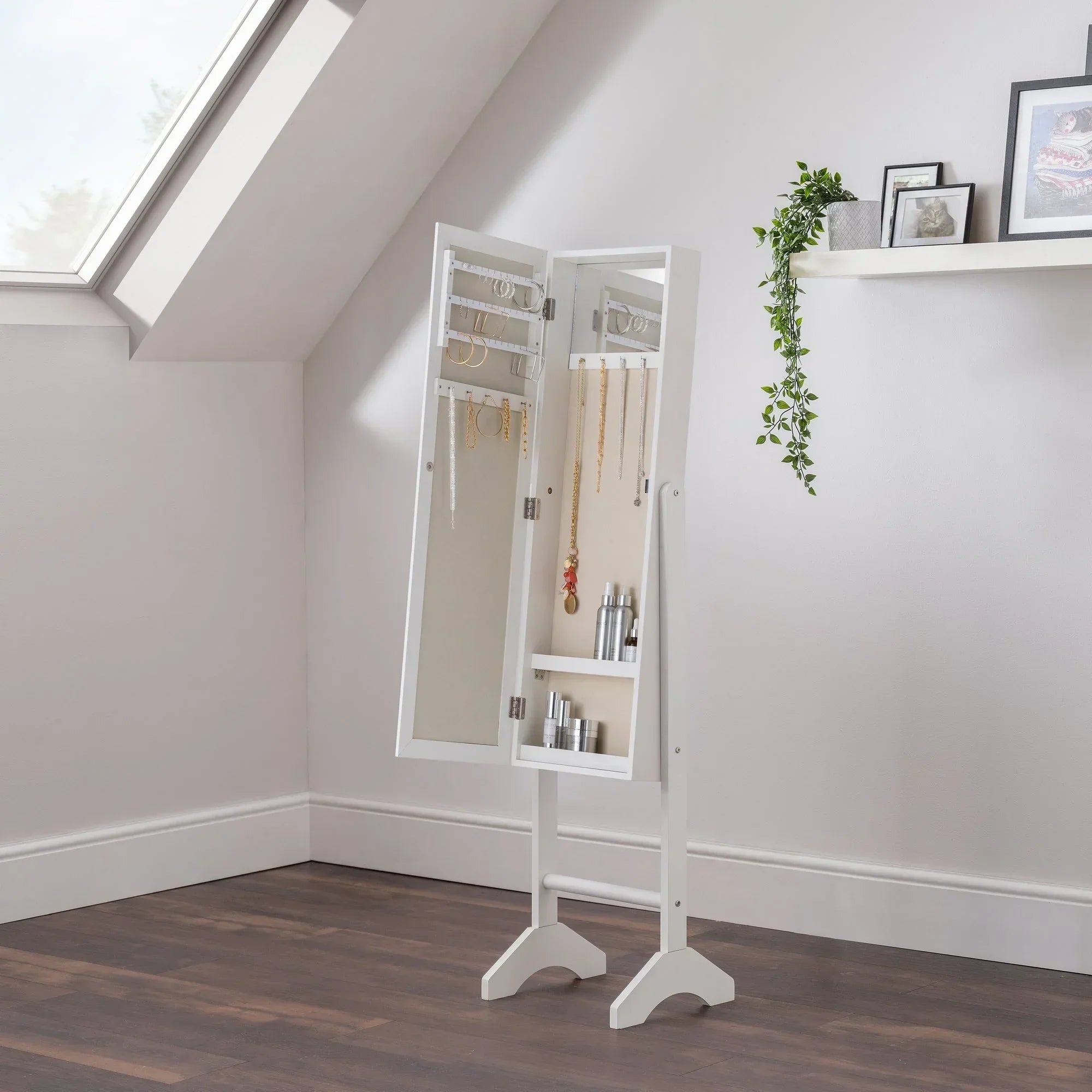 White jewellery mirror cabinet standing open with hanging necklaces and trays for storage