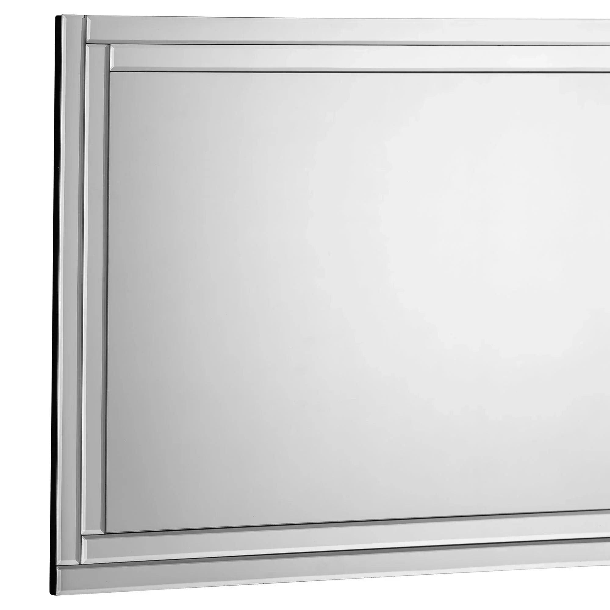Frameless rectangular wall mirror with decorative edge detail, close-up of corner