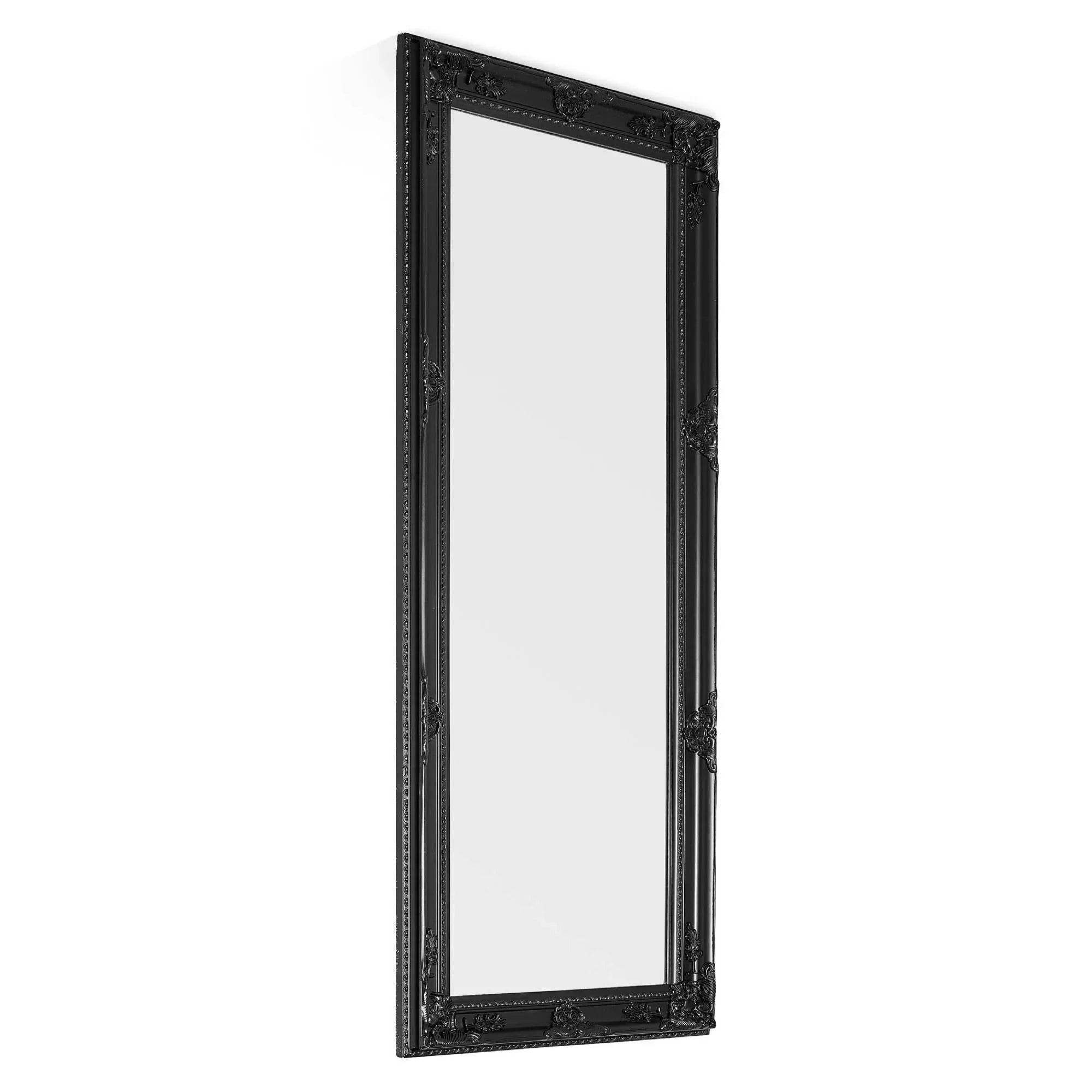 Tall black ornate wall mirror with decorative carved frame, angled side view