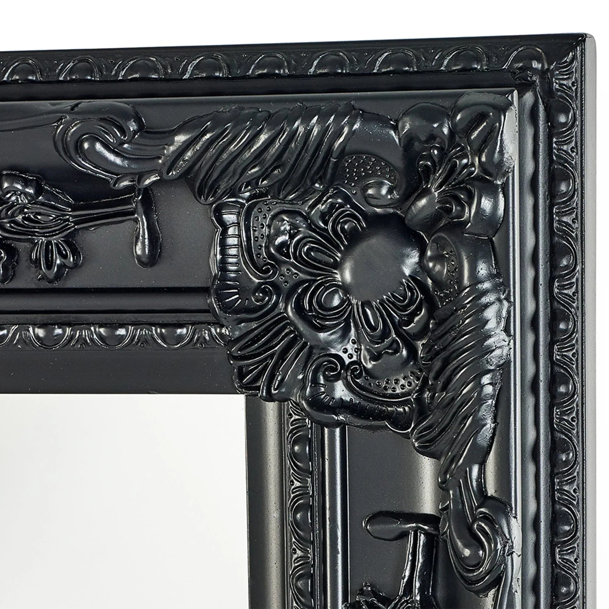 Close-up of ornate black mirror frame with detailed floral and scrollwork design