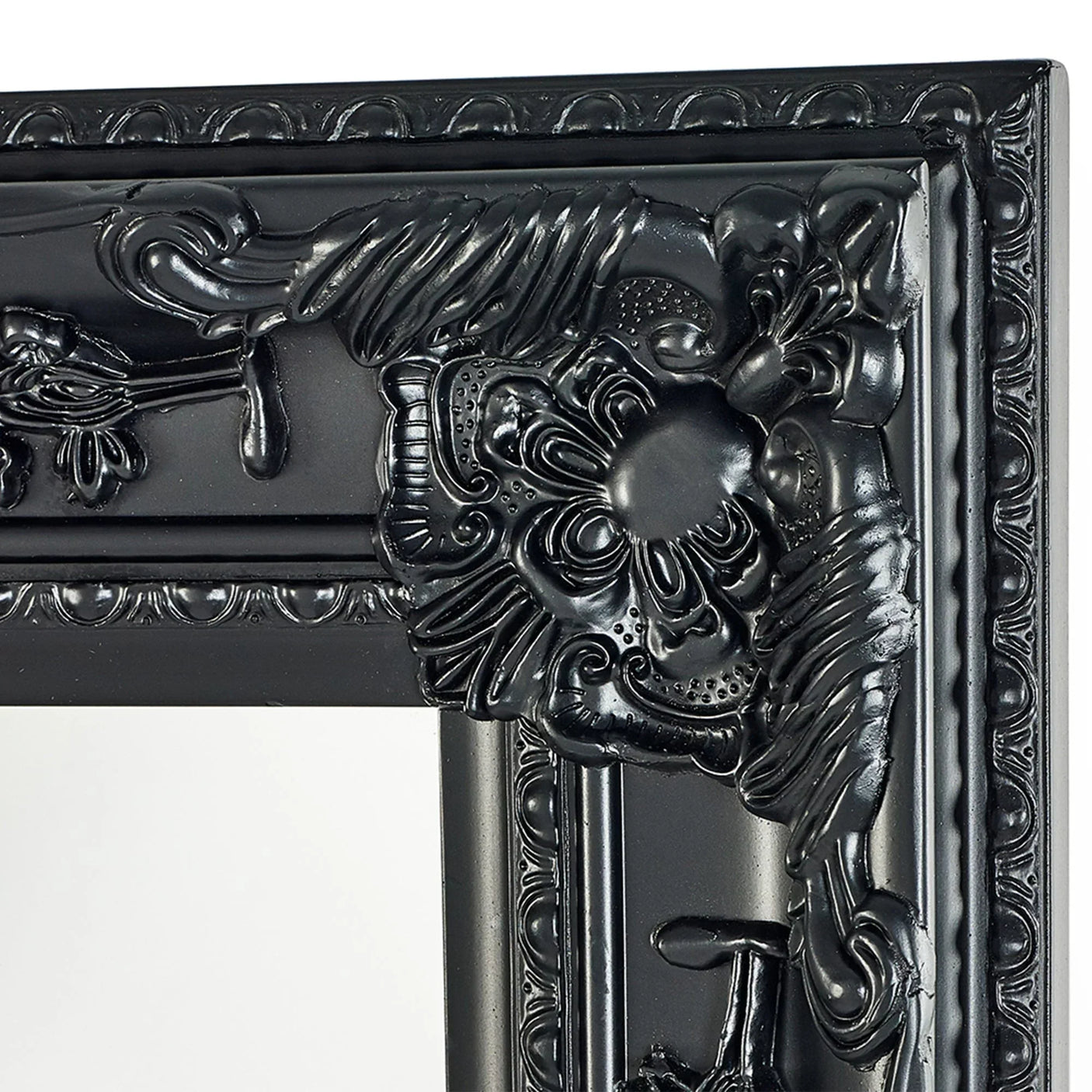 Close-up of ornate black mirror frame with detailed floral and scrollwork design