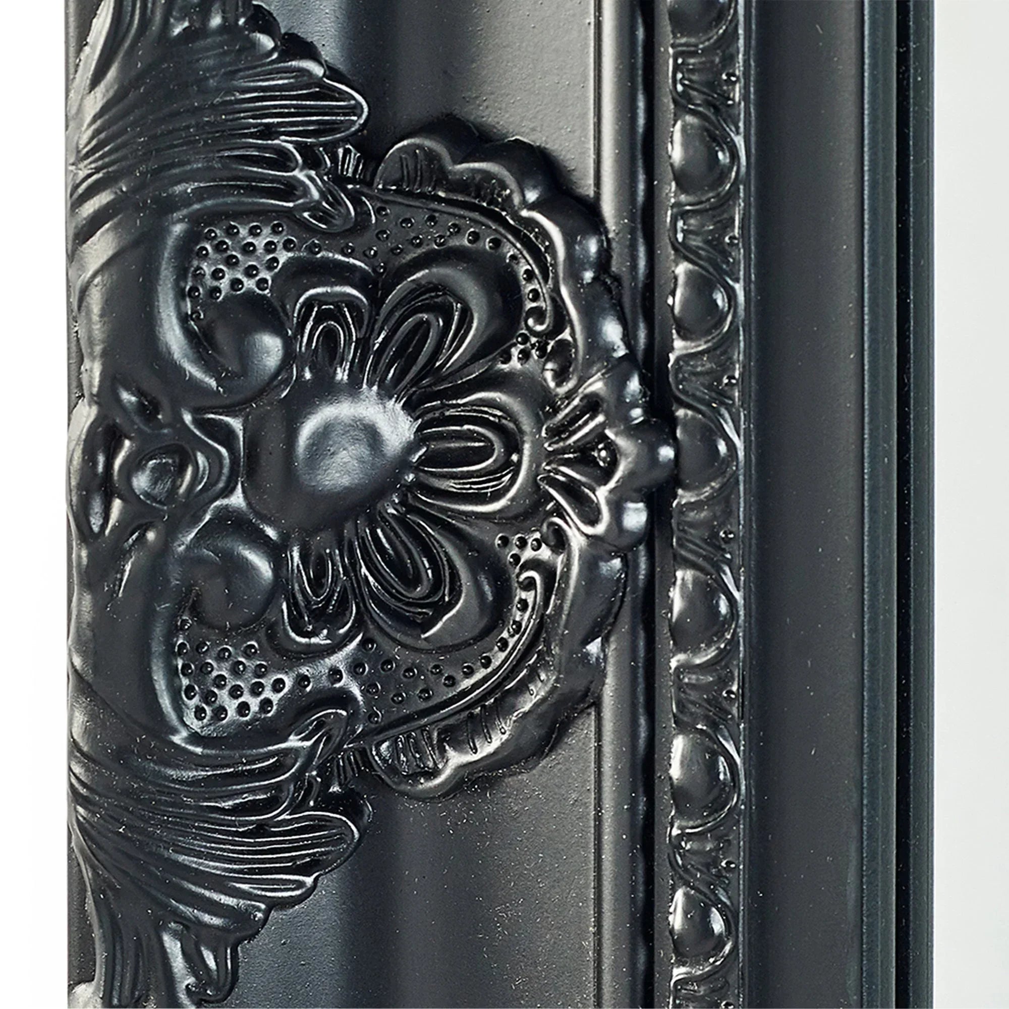 Black ornate mirror frame with floral embossed detailing and glossy finish