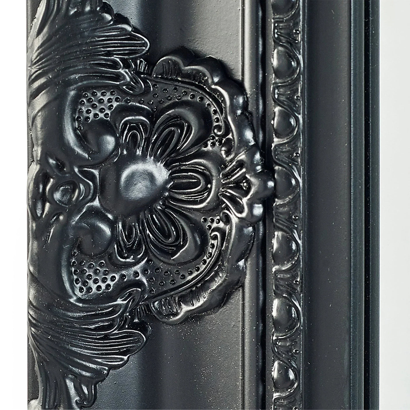 Black ornate mirror frame with floral embossed detailing and glossy finish