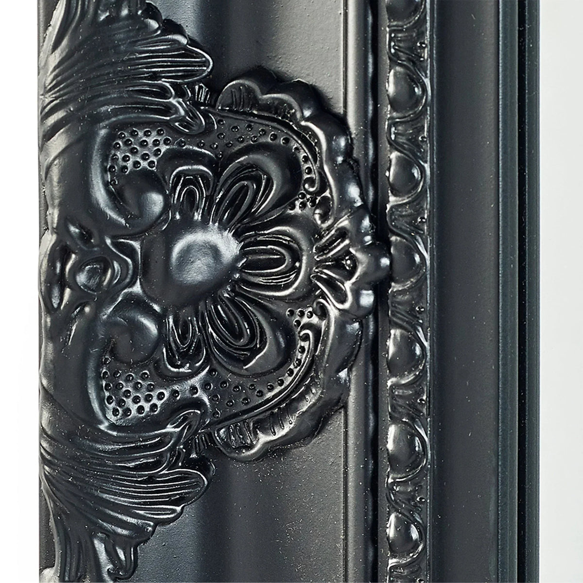 Black ornate mirror frame with floral embossed detailing and glossy finish