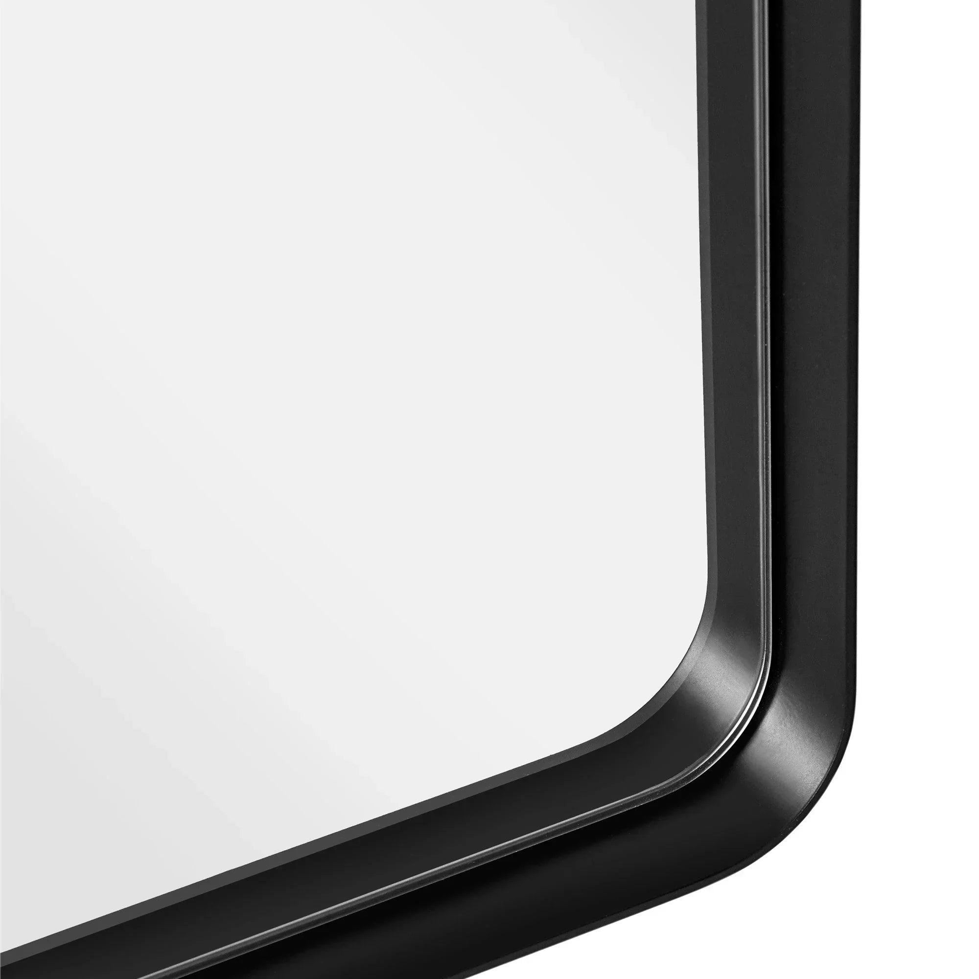 Close-up of rectangular mirror with black metal frame and rounded corner