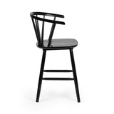 Top-down view of black wooden bar stool seat and spindle backrest beside kitchen island
