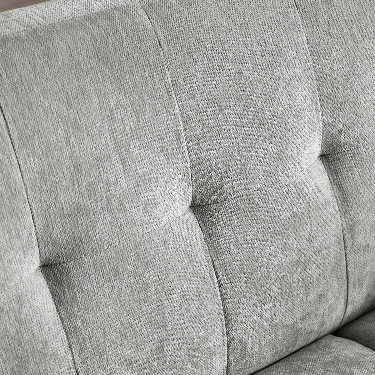 Grey fabric sofa backrest with square tufted stitching detail