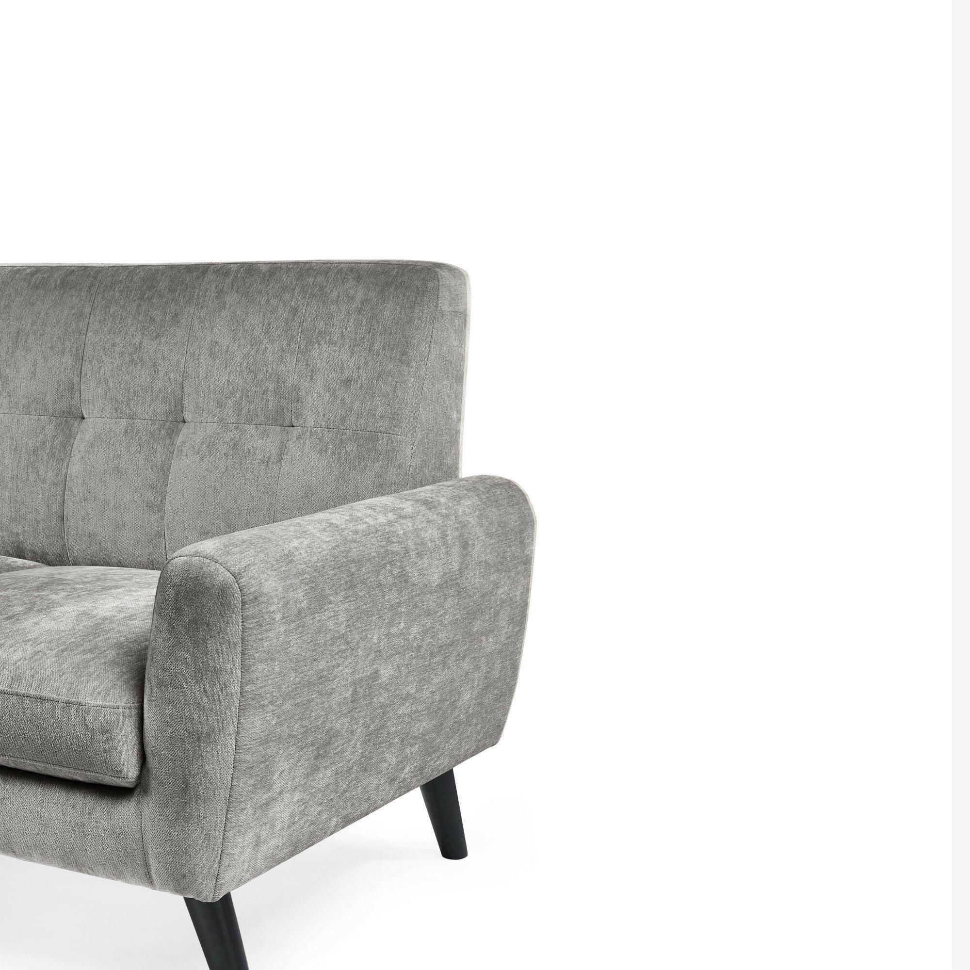 Grey fabric sofa with tufted backrest and angled black legs, close-up of arm and seat