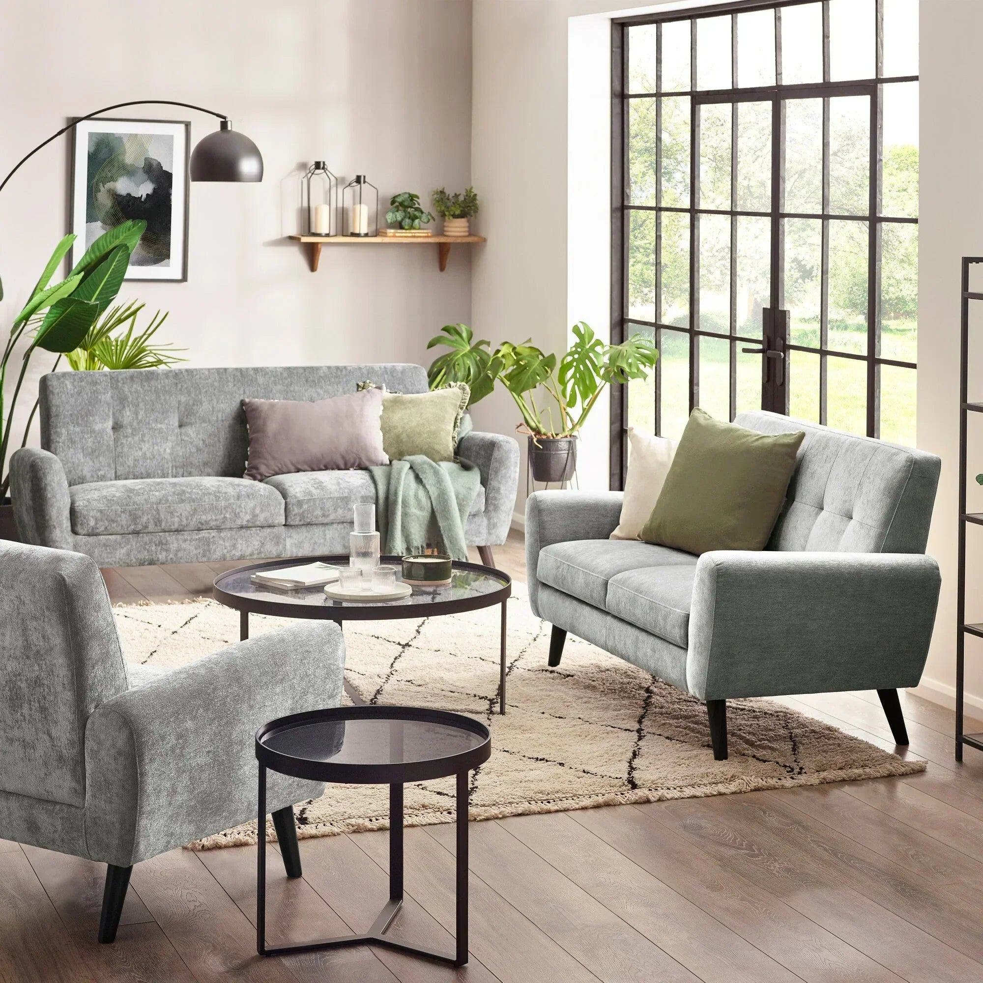 Dove grey Monza sofa range with cushions in bright living room, glass tables, modern decor