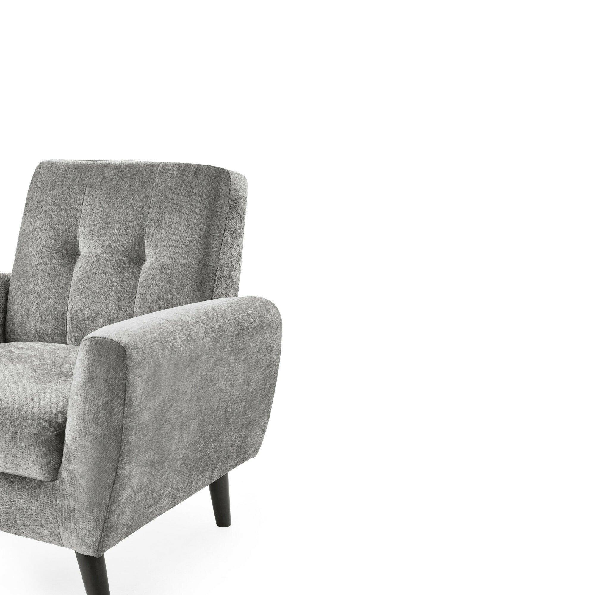 Grey fabric armchair with tufted backrest and angled wood legs, side angle view