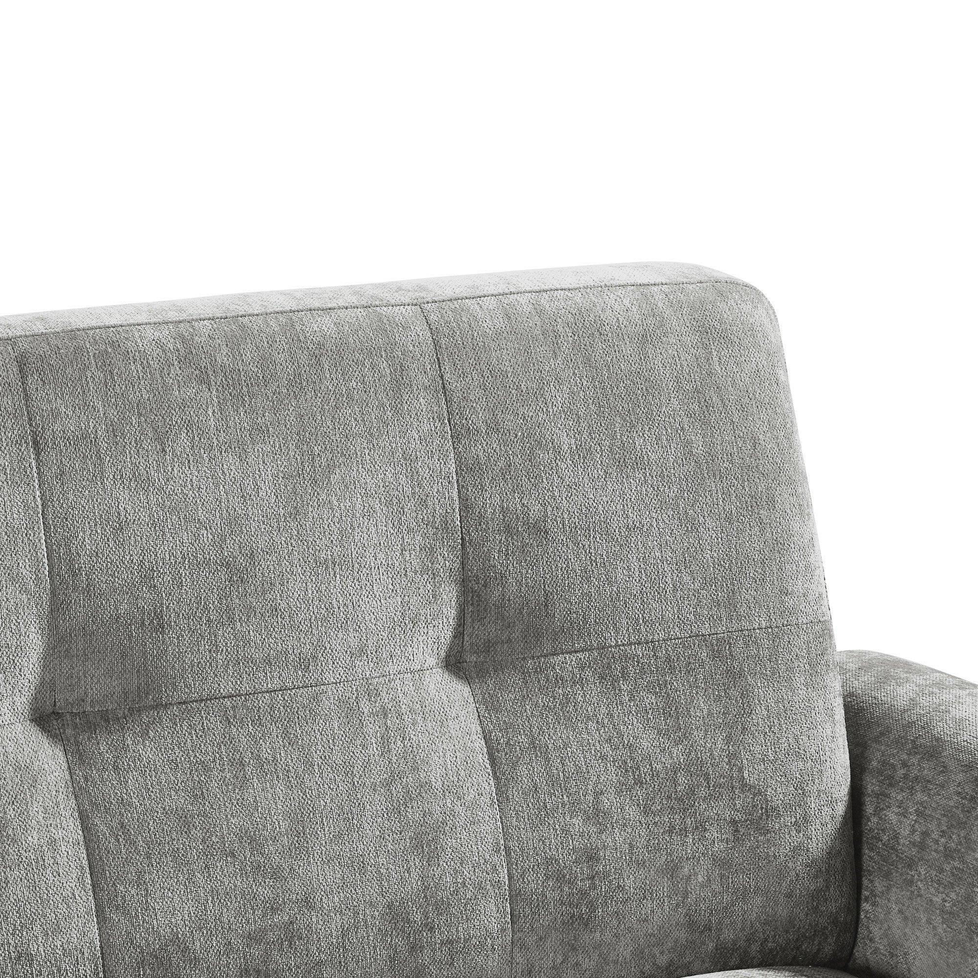 Closeup of grey fabric sofa backrest with stitched panel detailing and armrest