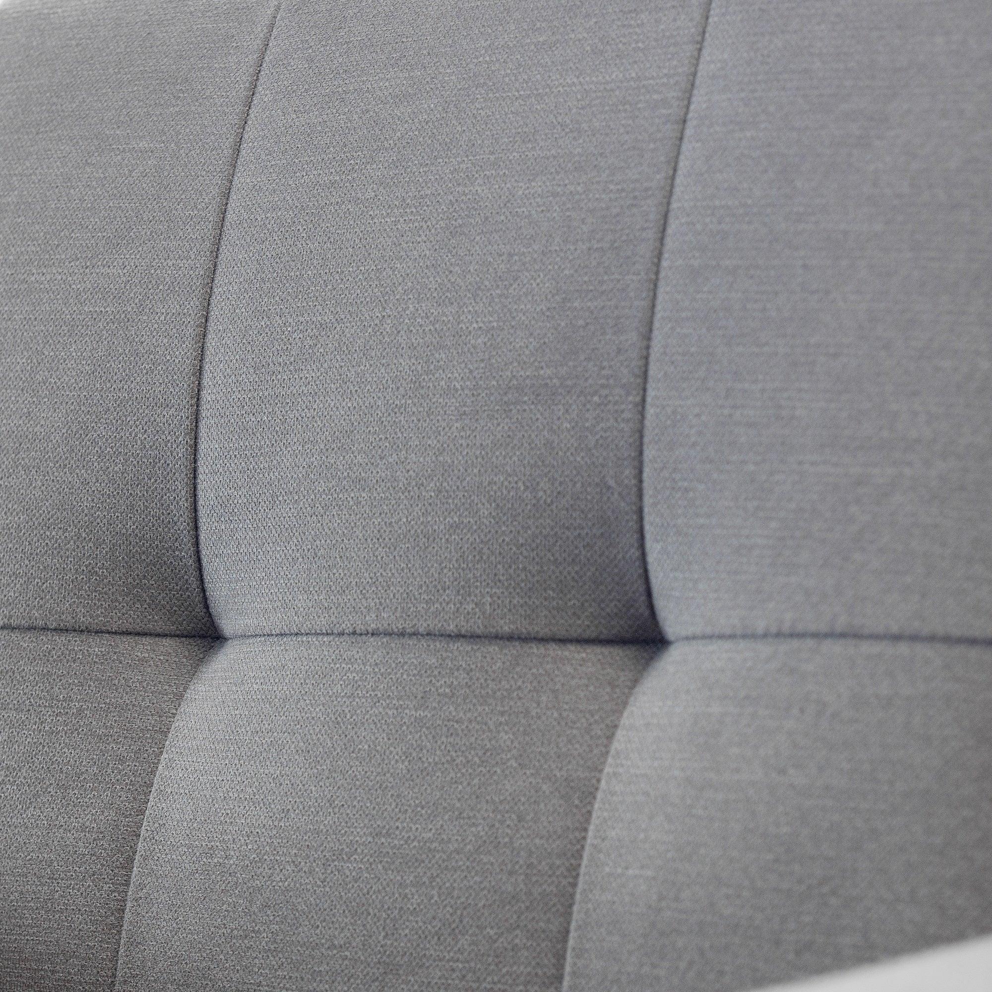 Close-up of grey fabric sofabed backrest with stitched panel detail