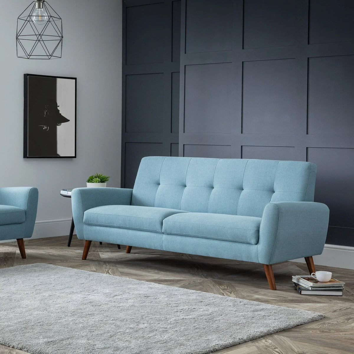 Monza blue fabric sofa set with wooden legs in modern living room with grey rug