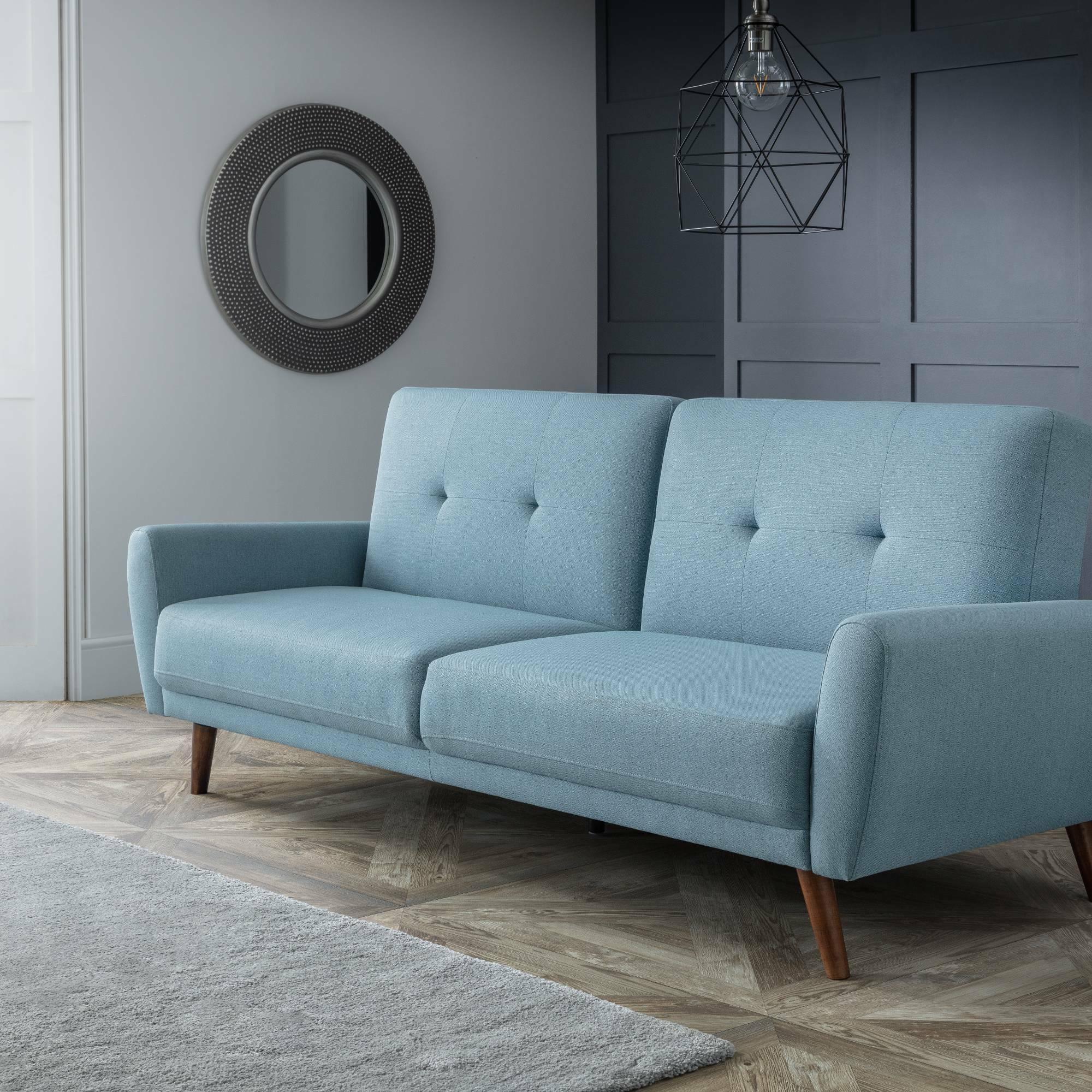 Monza blue sofabed with wooden legs in modern living room with geometric pendant light