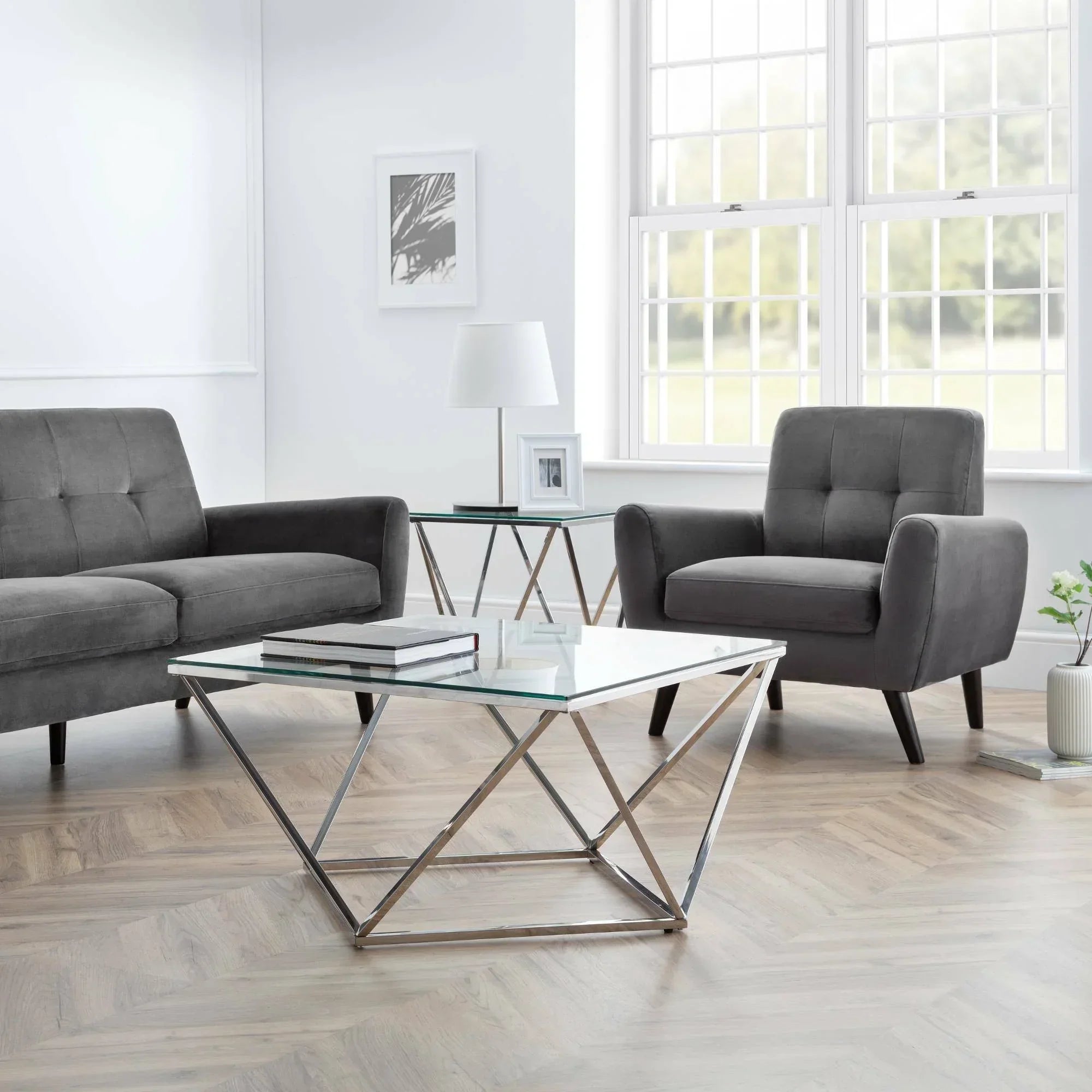 Monza grey velvet 3 seater sofa and armchair in modern living room with glass tables