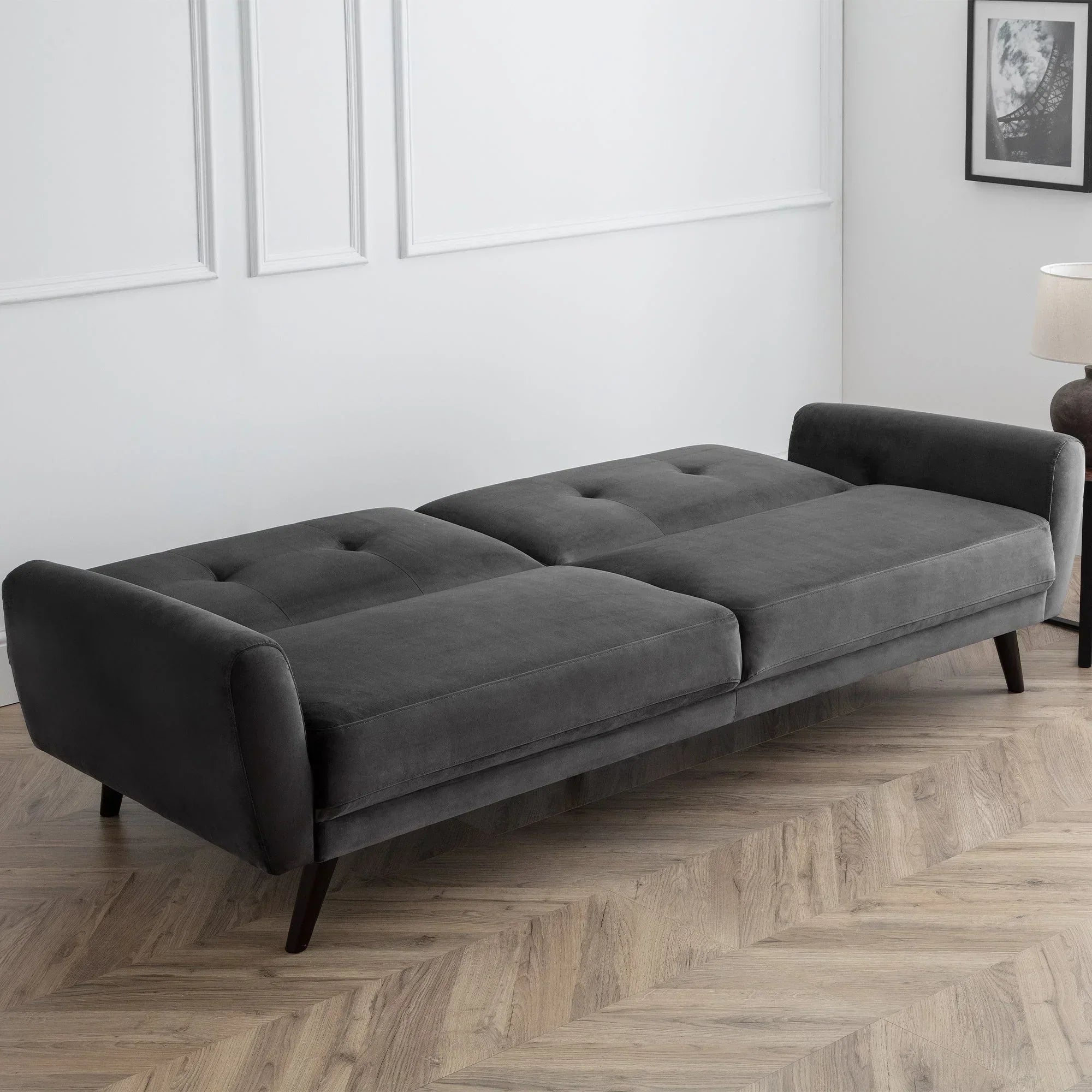 Monza grey velvet sofabed extended in modern room with herringbone wood flooring
