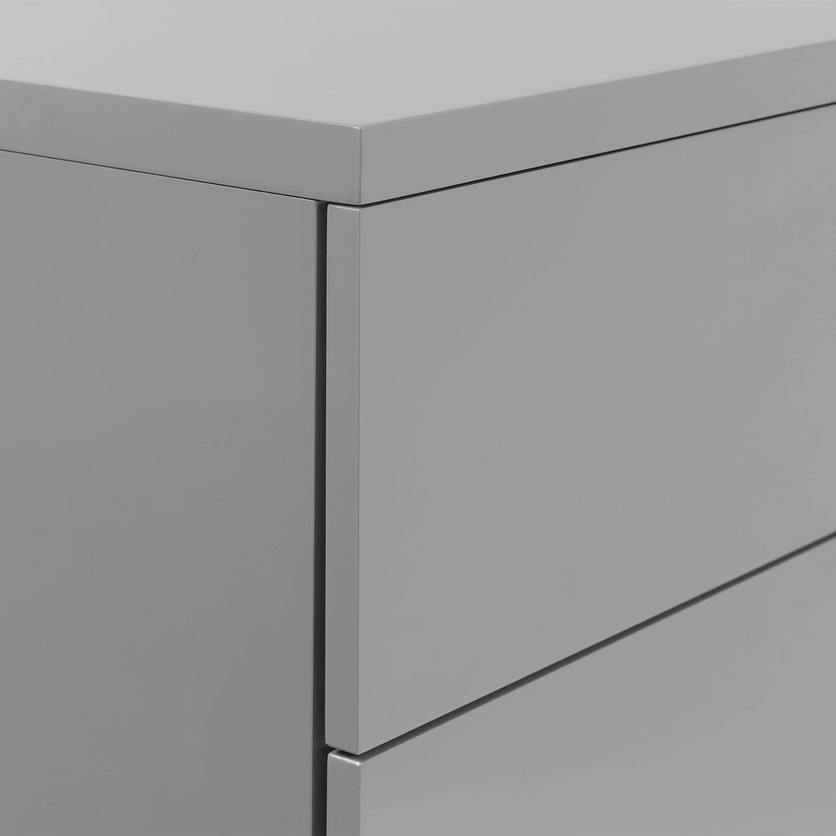 Glossy grey chest of drawers corner showing smooth finish and clean lines