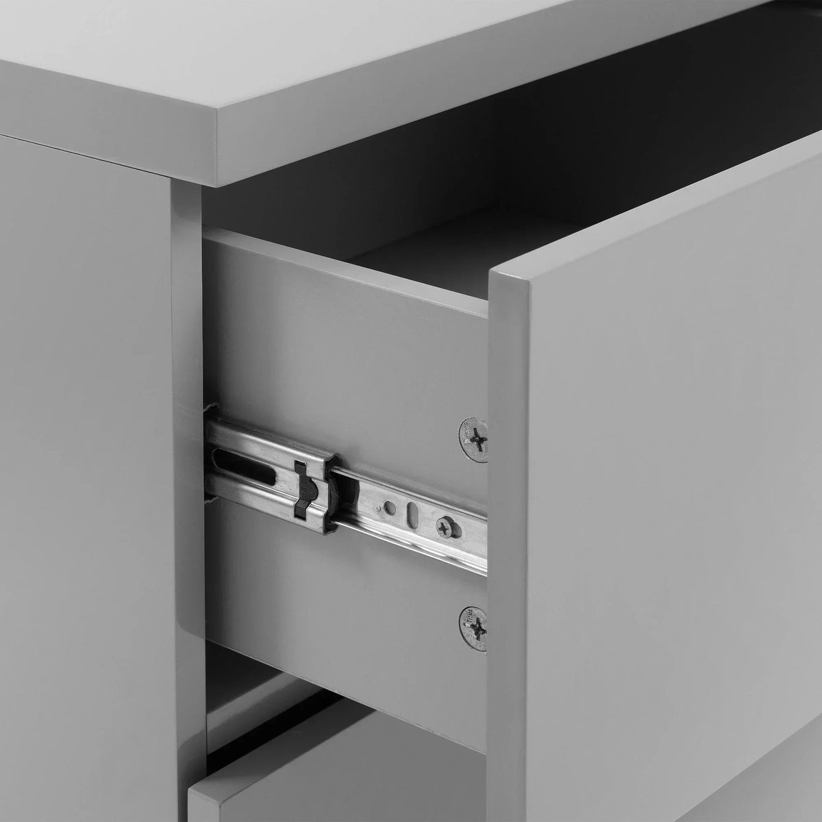 Close-up of modern grey chest of drawers with metal drawer runner detail