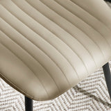 Close-up of beige chair seat upholstery with vertical stitching on light patterned rug