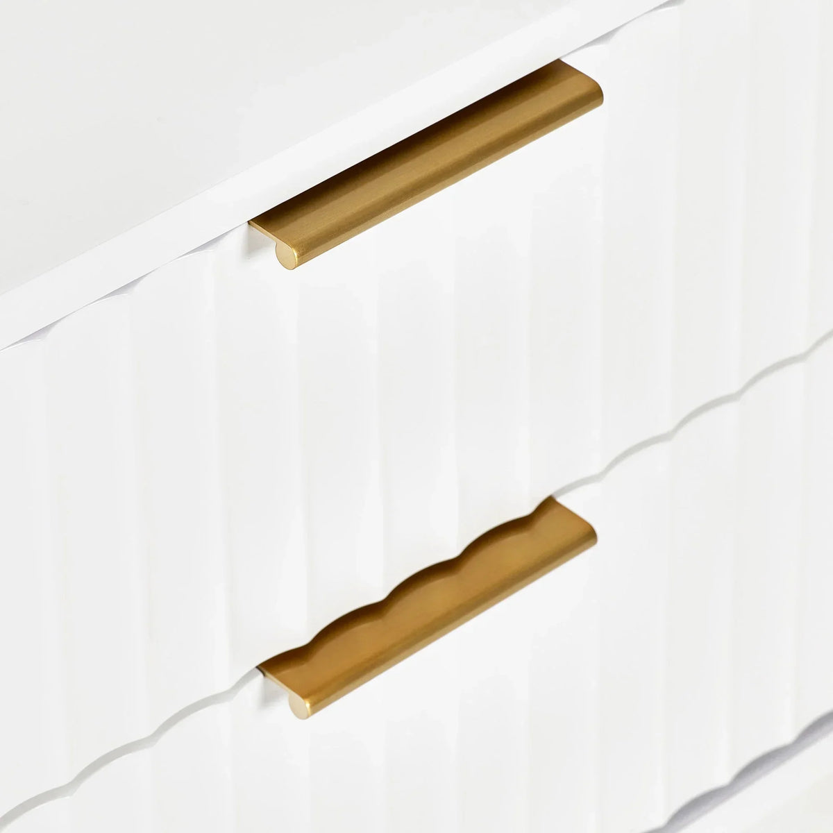 White chest of drawers with gold handles and textured drawer fronts