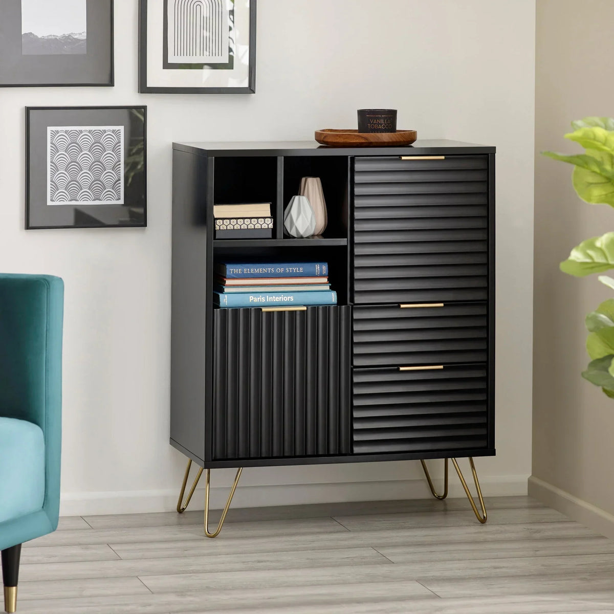 Black sideboard cabinet with ribbed doors, gold handles, open shelving and metal legs