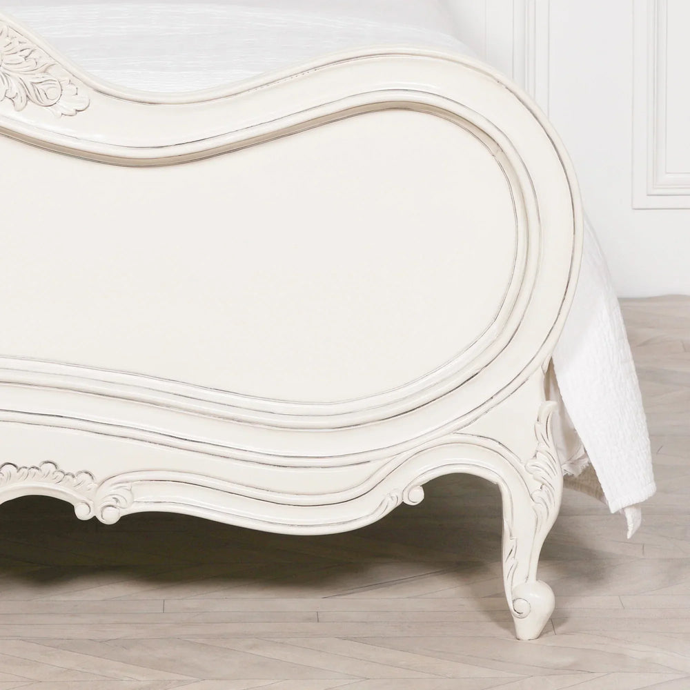 Cream French style bed footboard with carved detailing and curved wooden legs