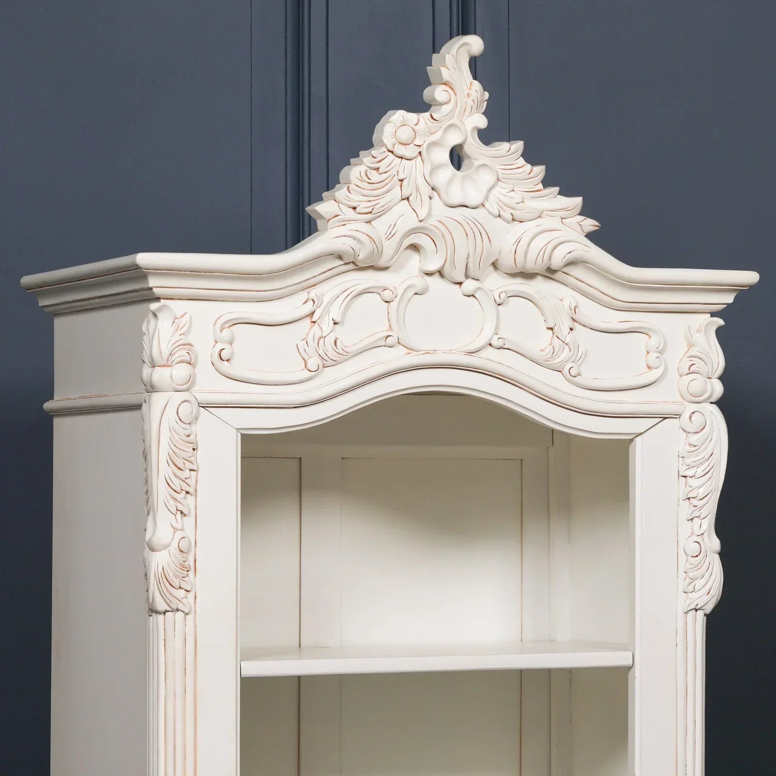 French style cream display cabinet with ornate carved wood detail and open shelving