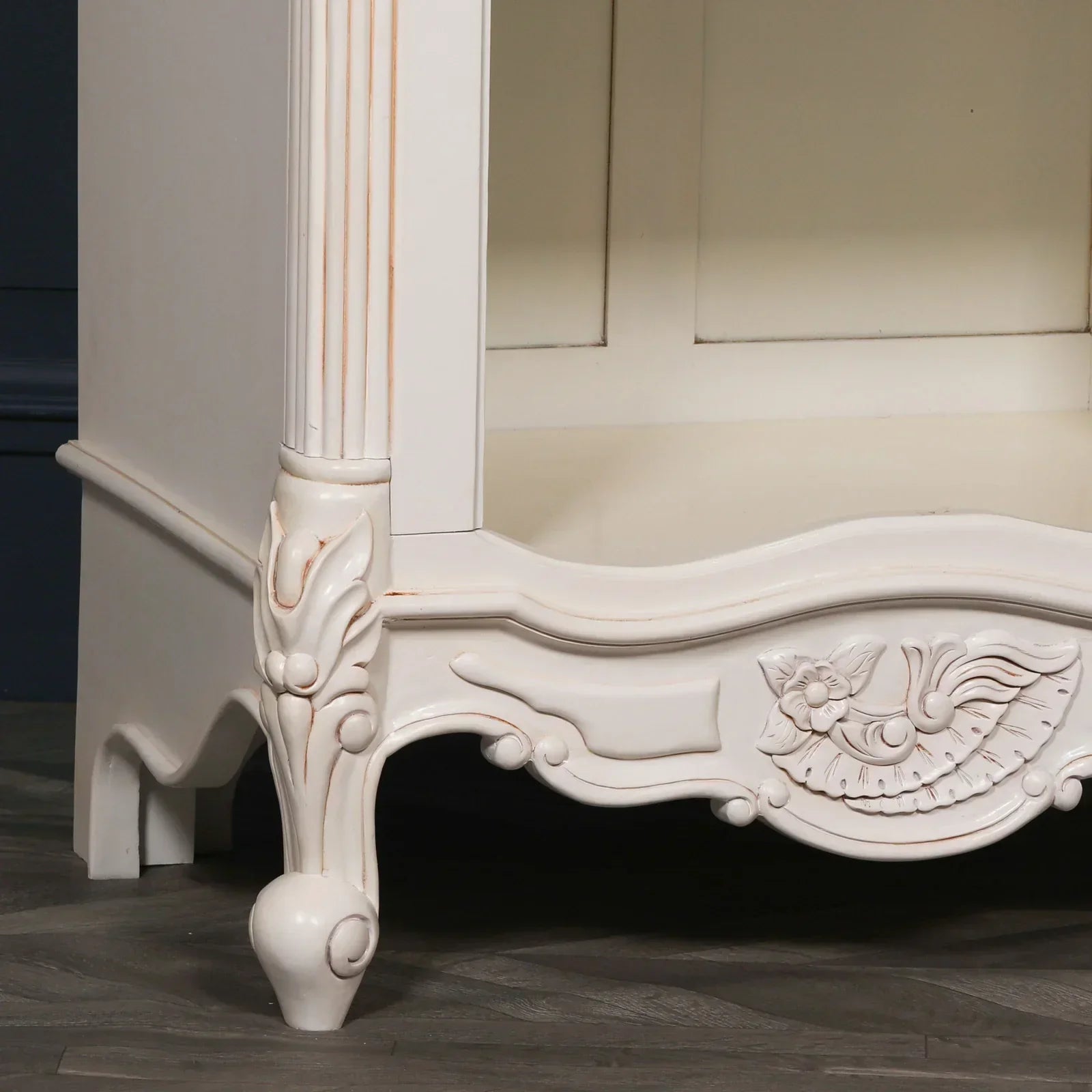 Carved wood cabinet base with floral motifs and curved legs in cream finish