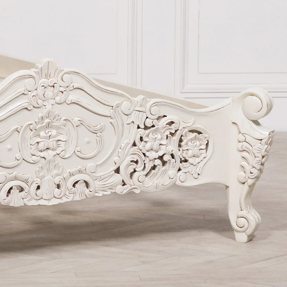 Cream carved wood bed footboard with floral detailing and ornate scrollwork