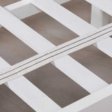 Close-up of a white wooden bed frame on a wooden floor.