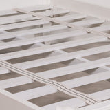 White wooden bed slats with two beige woven mattress support strips, shown close-up on a bed frame.