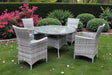 Grey rattan dining set with round glass table and four chairs on garden lawn