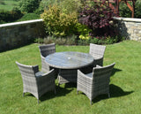Grey rattan outdoor dining set with glass-top round table and four chairs on garden lawn