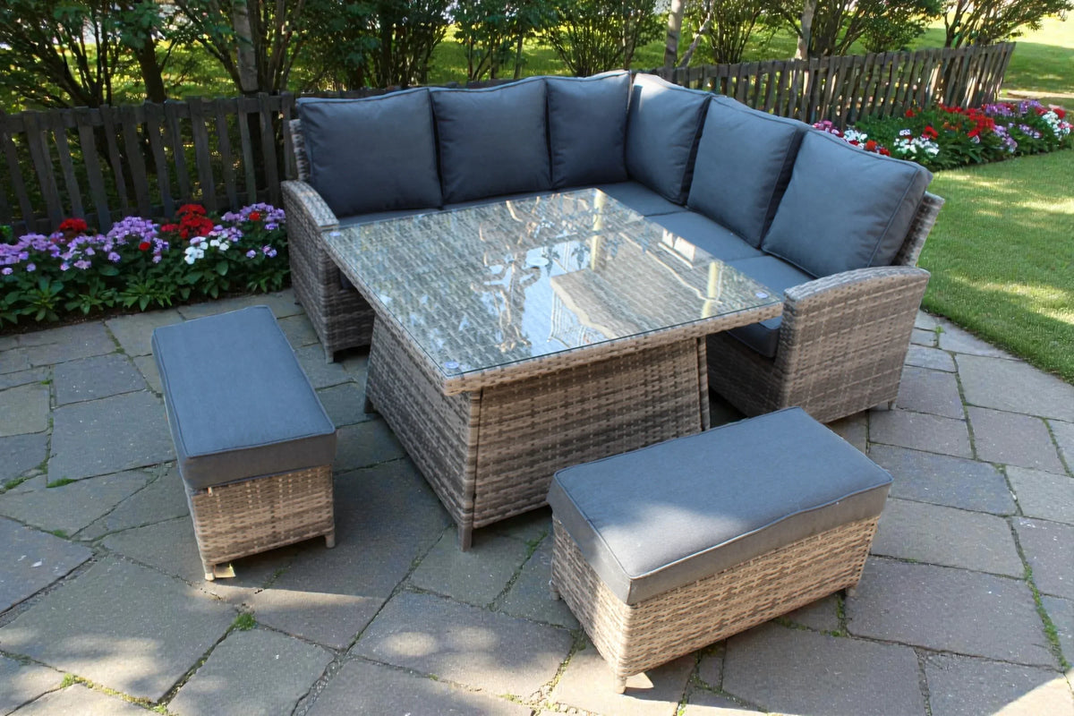 Grey rattan garden corner sofa set with cushions, glass table and benches on patio