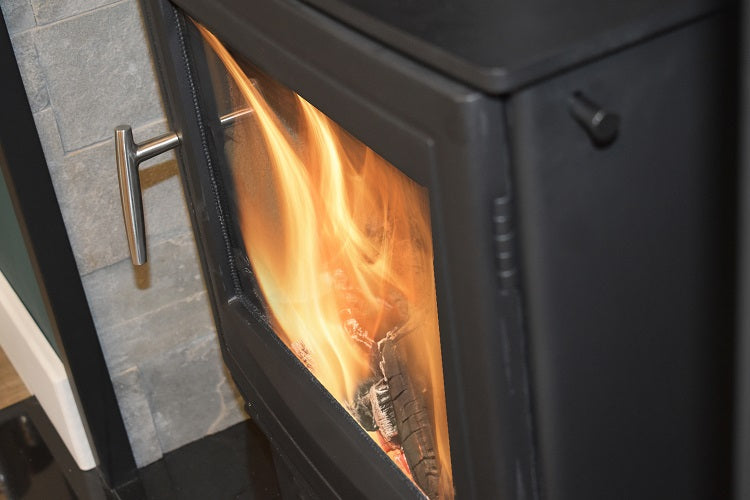 Side view of Mourne Eco 5 Wide multi-fuel stove with flame visible
