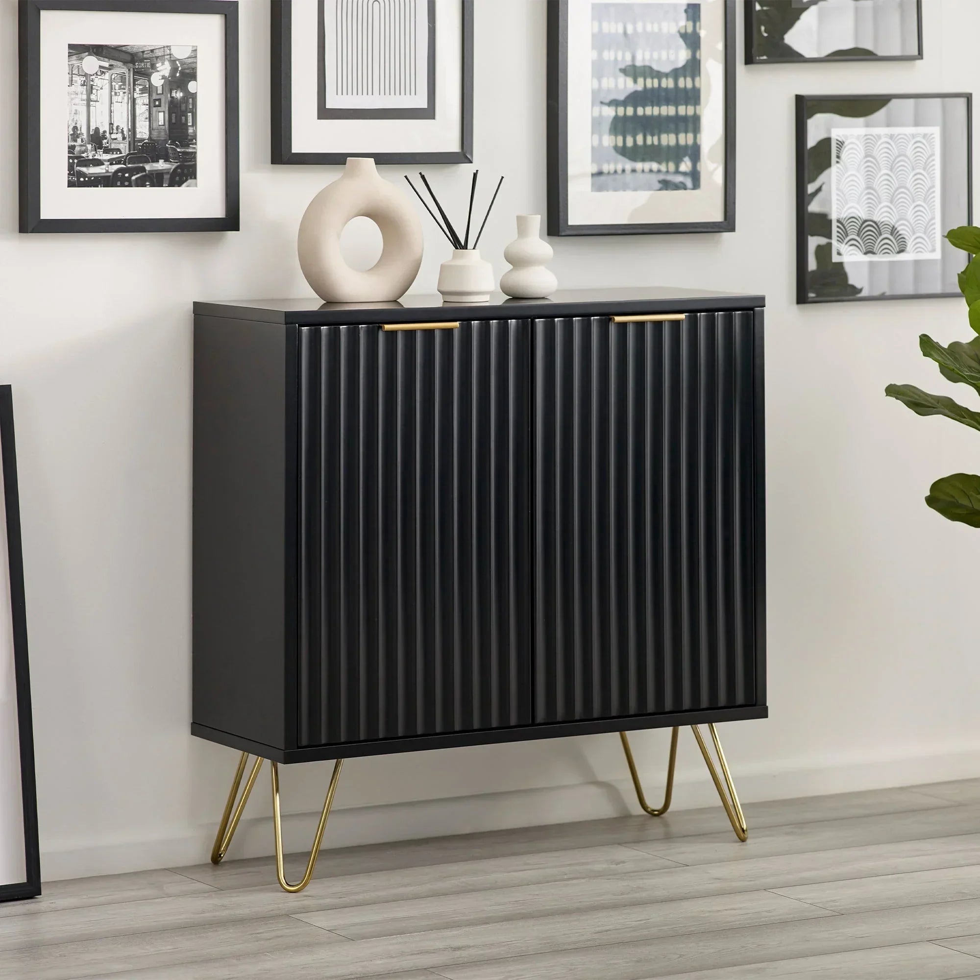Black compact sideboard with ribbed doors and gold legs in modern living room