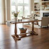 Wooden dining table in a bright living room with large windows and bookshelves.
