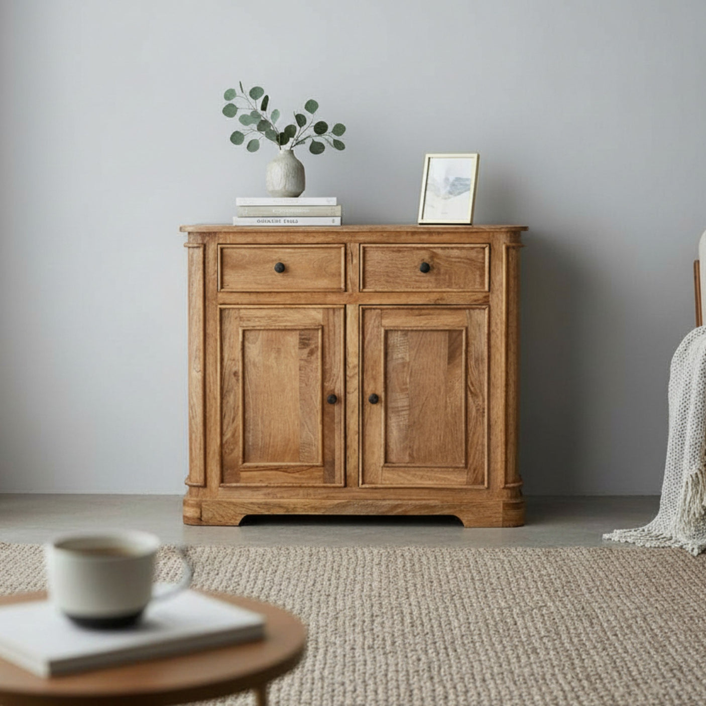 Wooden sideboard with decorative items in a room with a neutral color scheme