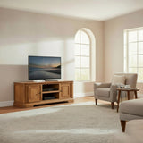 Wooden TV stand with a television displaying a beach scene in a room with a window.