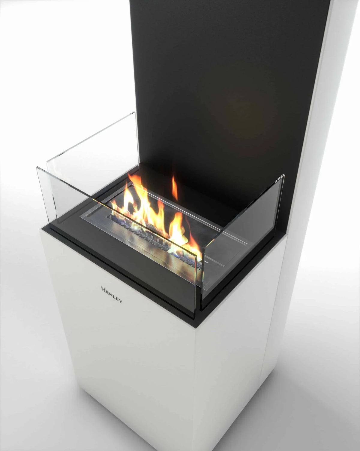 Modern freestanding bioethanol fireplace with glass sides and visible flames, white base