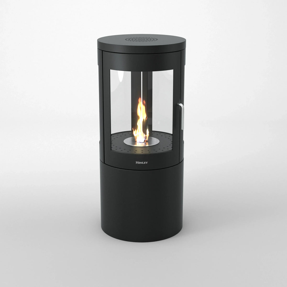 Black cylindrical bioethanol stove with glass panels and visible flame on white background