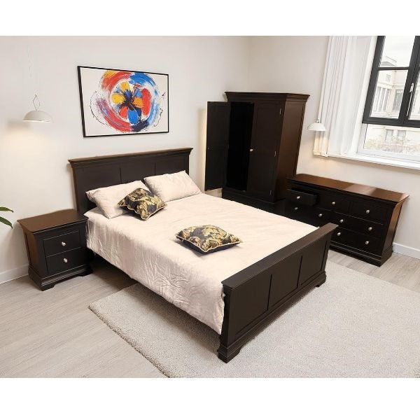 A dark brown wooden bedroom furniture set including a bed frame, nightstand, dresser, and wardrobe, styled in a modern bedroom with white bedding and decorative pillows.