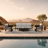 Light grey cushioned seating with black metal frame on grey outdoor rug by poolside | Home Centre Di