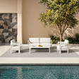 Cream fabric cushioned seating set with white frame beside pool and stone wall | Home Centre Direct