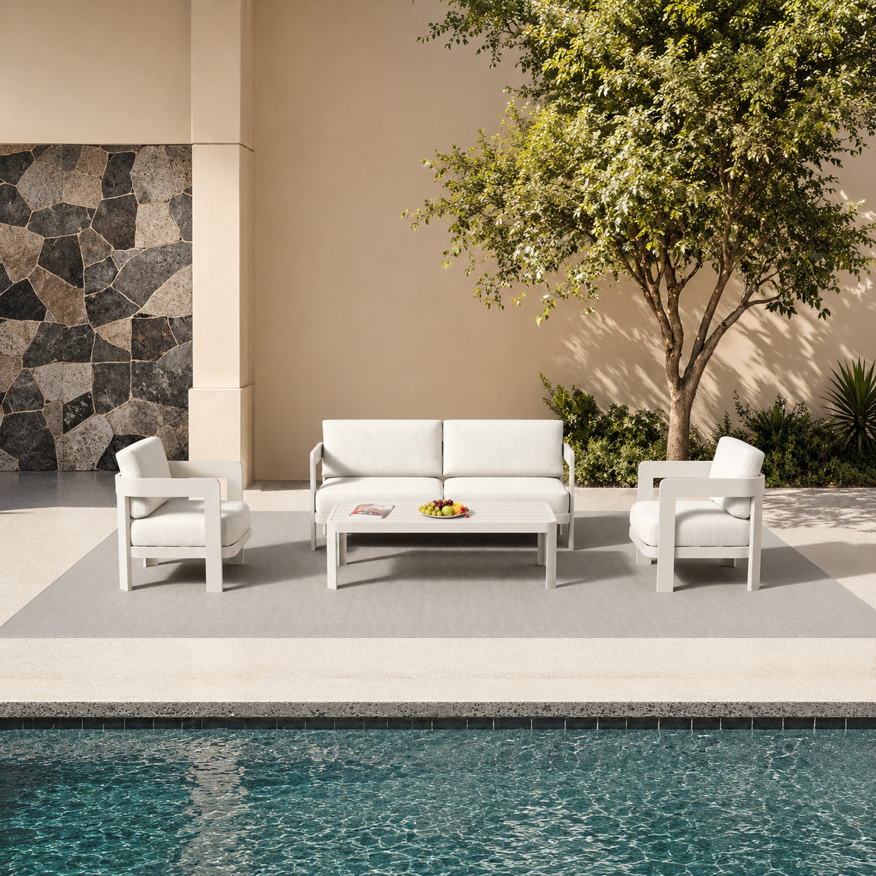 Cream fabric cushioned seating set with white frame beside pool and stone wall | Home Centre Direct