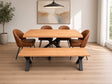 A modern dining set featuring a rectangular light oak wood table with a black metal pedestal base, a matching long bench, and four brown leather upholstered chairs, shown in a bright, contemporary dining room.