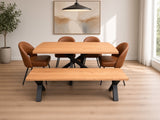 A modern dining set featuring a rectangular light oak wood table with a black metal pedestal base, a matching long bench, and four brown leather upholstered chairs, shown in a bright, contemporary dining room.