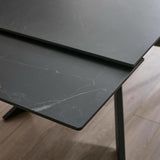 Close-up showing extended table top pieces with black marble pattern and clean edges